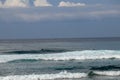 Surfers are waiting for a convenient wave on their surfboards. Tropical surfers paradise with Nyang Nyang beach on Bali island. Royalty Free Stock Photo