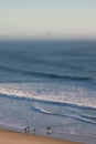 Surfers walking along beach Royalty Free Stock Photo