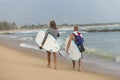 Surfers walking on the beach