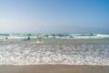 Surfers on the waves. Famara Beach Playa de Famara, popular surfing beach in Lanzarote