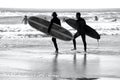 Surfers on the waves at Llangennith Beach on the Gower Peninsula