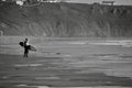 Surfers on the waves at Llangennith Beach on the Gower Peninsula