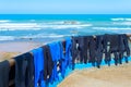 Surfers wetsuits drying on beach