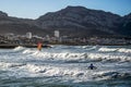 Surfers and windsurfers in action