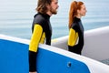 Surfers,young couple walking with board on beach. water sports. Active Lifestyle Royalty Free Stock Photo