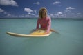 Surfgirl in pink swimsuit on Mauritius Royalty Free Stock Photo