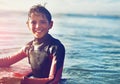 Surfing is all the adventure I need. Shot of a young boy out surfing. Royalty Free Stock Photo