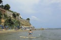 Surfing boy at Nettuno sea.Italian coast and beach.Tourist destination.