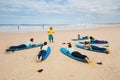 Surfing coach instructs novice surfers near Peniche