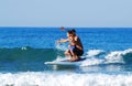 Father and son surfing the wave Royalty Free Stock Photo