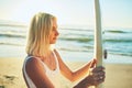 Surfing is a lifestyle. an attractive young woman standing in a swimsuit holding a surfboard on the beach. Royalty Free Stock Photo