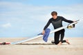 Surfing, man and getting ready with surfboard on beach with wetsuit, blue sky and cleaning with mock up space. Extreme Royalty Free Stock Photo