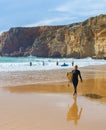Surfing man surfboard beach Portugal Royalty Free Stock Photo