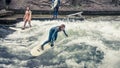 Surfing in Munich at Englischer Garten is dangerous but possible: at one channel crossing the par