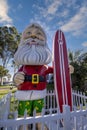 Surfing Santa under a Cloudy Sky