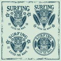 Surfing set of vector emblems, badges, labels, stickers or logos with tiki head and surfboards. Illustration in colored Royalty Free Stock Photo