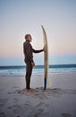 Surfing, surfboard and senior man on beach for water sports adventure trip standing in sand watching sea waves at sunset Royalty Free Stock Photo