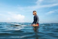 Surfing. Surfer Man Sitting On Surfboard Portrait. Handsome Guy In Wetsuit In Ocean. Royalty Free Stock Photo