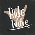 Surfing typography for t shirt print. T-shirt graphics. Surfing shaka hand with lettering Ride the wave Royalty Free Stock Photo