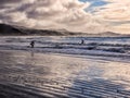 Surfing under a winter sunset