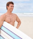 Surfing is a way of life. A young male surfer getting ready to go for a surf on a hot summers day. Royalty Free Stock Photo