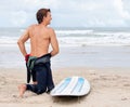 Surfing is a way of life. A young male surfer getting ready to go for a surf on a hot summers day. Royalty Free Stock Photo