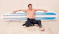 Surfing is a way of life. A young male surfer getting ready to go for a surf on a hot summers day. Royalty Free Stock Photo