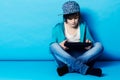 Surfing the web on his tablet. A young boy sitting on his digital tablet in the studio. Royalty Free Stock Photo
