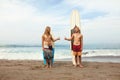 Surfing. Young Surfers Standing On Sunny Beach. Smiling Men Showing Thumb Up Near Surfboards In Sand. Royalty Free Stock Photo