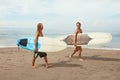 Surfing. Young Surfers With Surfboards. Smiling Handsome Men Walking On Ocean Beach. Royalty Free Stock Photo