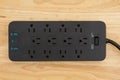 Surge protector with USB protection on wood desk Royalty Free Stock Photo