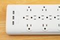 Surge protector with USB protection on wood desk Royalty Free Stock Photo