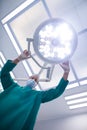 Surgeon adjusting surgical light in operation theater Royalty Free Stock Photo