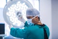 Surgeon adjusting surgical light in operation theater Royalty Free Stock Photo