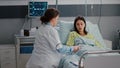 Surgeon doctor monitoring hospitalized sick woman during cardiology appointment Royalty Free Stock Photo