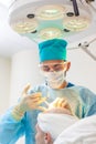 The surgeon gives injections to the head. Baldness treatment. Hair transplant. Surgeons in the operating room carry out