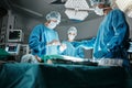 Surgeon group, people and operating room at hospital in scrubs, ppe and help for emergency healthcare procedure. Doctors Royalty Free Stock Photo