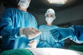 Surgeon, hands and scalpel in operating room at hospital in scrubs, ppe or emergency healthcare procedure. Doctors Royalty Free Stock Photo