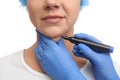 Surgeon with marker preparing woman for operation against white, closeup. Double chin removal