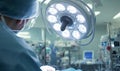A surgeon performing surgery in an operating room, illuminated by a surgical light Royalty Free Stock Photo
