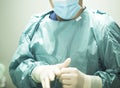 Surgeon putting on gloves Royalty Free Stock Photo