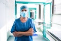 Surgeon standing in corridor at hospital Royalty Free Stock Photo