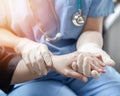 Surgeon, surgical doctor, anesthetist or anesthesiologist holding patient's hand for health care trust