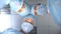 Surgeon team in masks ready for operation, patient pov in consciousness Royalty Free Stock Photo