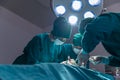 The surgeon team is working in the operating room. The surgeon is saving the patient`s life Royalty Free Stock Photo