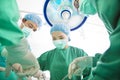 Surgeon team working together in a surgical room Royalty Free Stock Photo