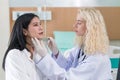 A surgeon uses a ruler to examine a patient in preparation for cosmetic surgery in doctors office. Cosmetology concept Royalty Free Stock Photo