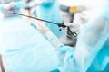 Nurse in sterile gloves holding laparoscopic instrument Royalty Free Stock Photo