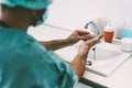 Surgeon washing hands before operating patient in hospital - Medical worker getting ready for fighting against corona virus Royalty Free Stock Photo