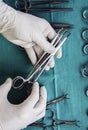 Surgeon working in operating room, hands with gloves holding scissors, conceptual image Royalty Free Stock Photo